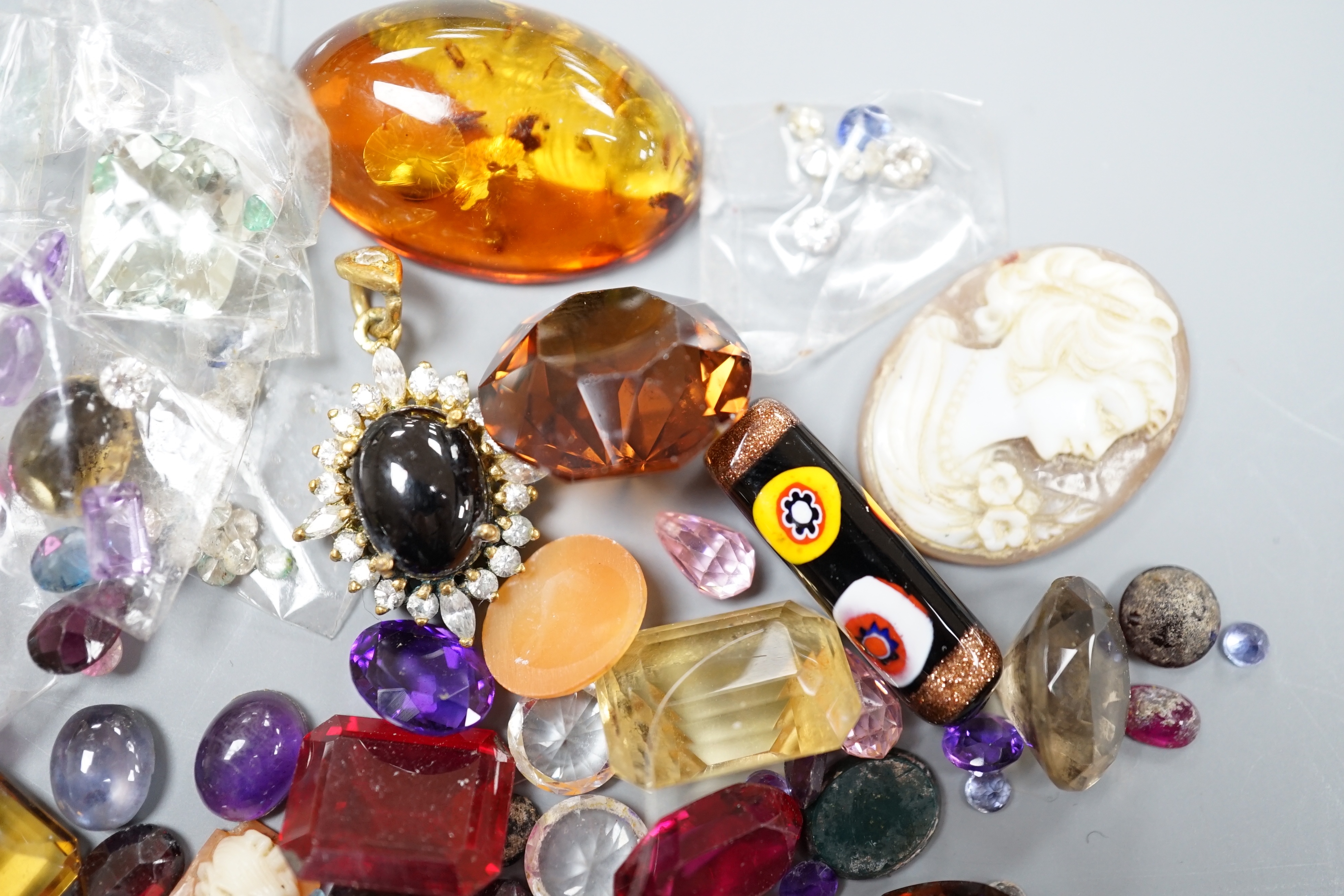 A quantity of assorted unmounted cut gemstones including small diamonds and other minor jewellery.